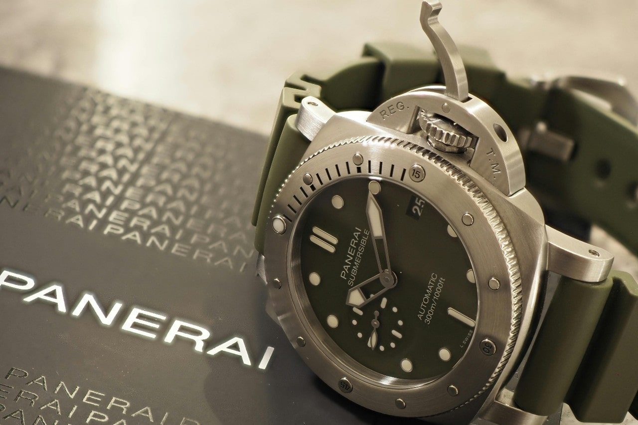 a Panerai watch sitting on a branded box