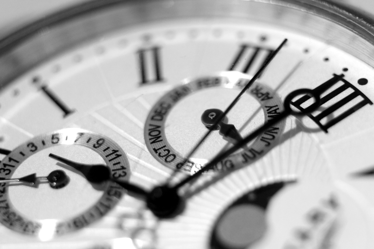 A black and white close-up of a watch’s dial featuring perpetual calendar complications.