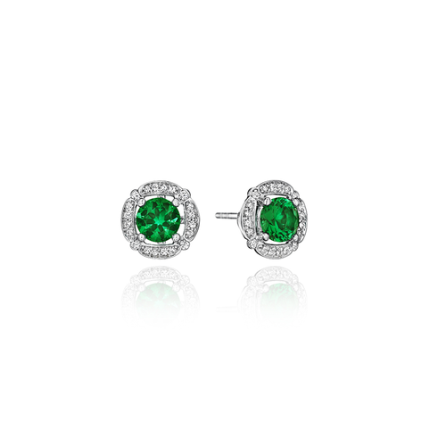 A white gold halo stud earrings featuring round green gemstones.