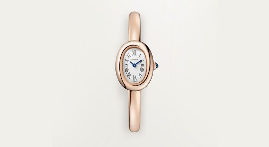 a rose gold Cartier watch with a small dial, polished case and strap