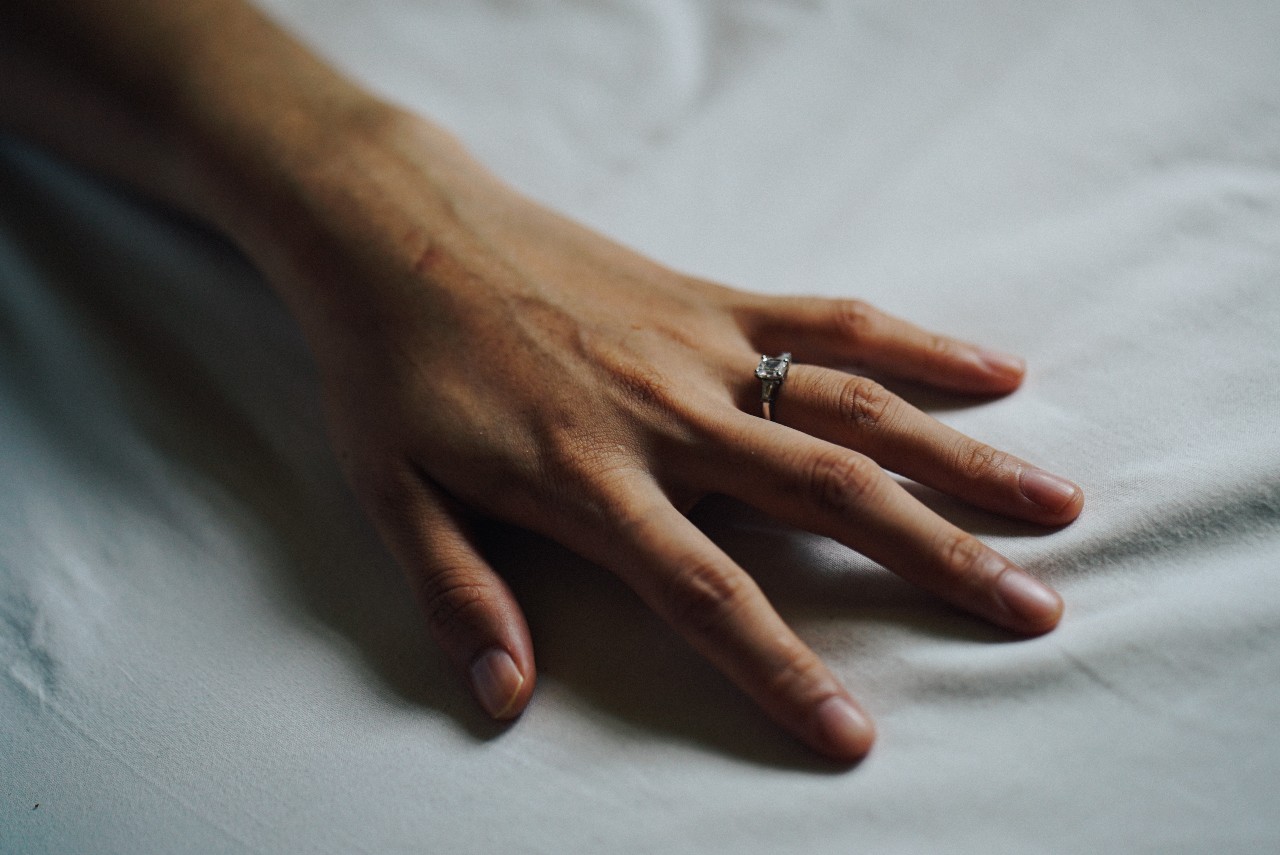 Resting ladie’s hand with a square cut diamond engagement ring Resting ladie’s hand with a square cut diamond engagement ring