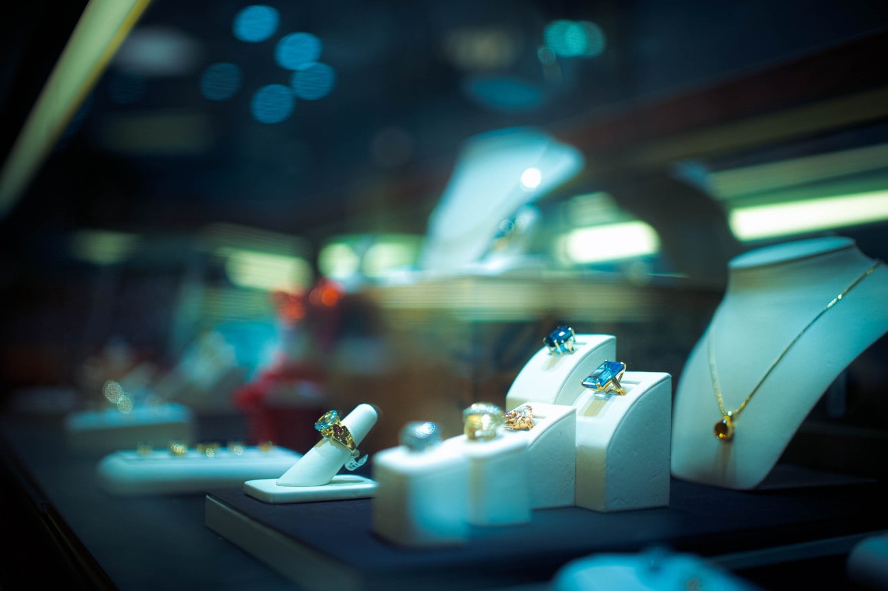 A close-up of an elegant jewelry display under low light. A close-up of an elegant jewelry display under low light.